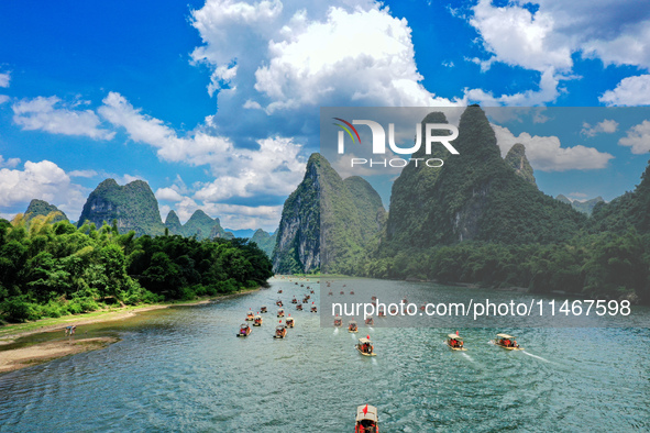 Tourists are visiting the Li River on a raft in Guilin, China, on August 8, 2024. 