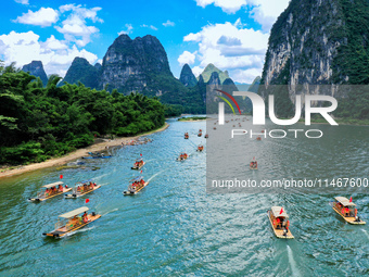 Tourists are visiting the Li River on a raft in Guilin, China, on August 8, 2024. (