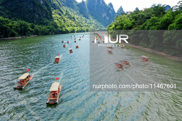 Tourists are visiting the Li River on a raft in Guilin, China, on August 8, 2024. 