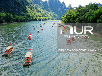 Tourists are visiting the Li River on a raft in Guilin, China, on August 8, 2024. (