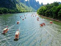 Tourists are visiting the Li River on a raft in Guilin, China, on August 8, 2024. (