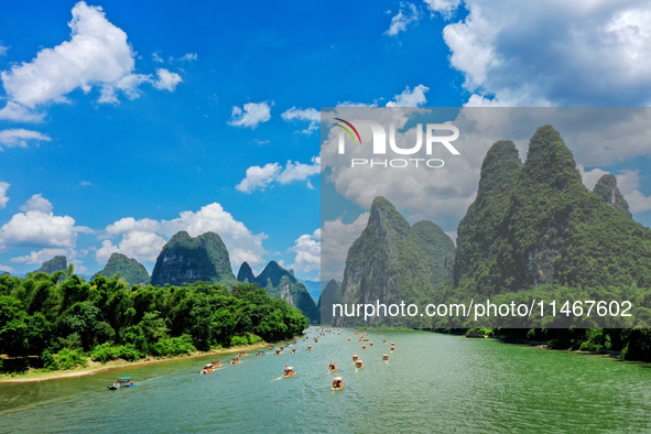 Tourists are visiting the Li River on a raft in Guilin, China, on August 8, 2024. 