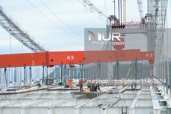 Workers are working at the construction site of Jinzhou Bridge in Xingyi, China, on August 11, 2024. 