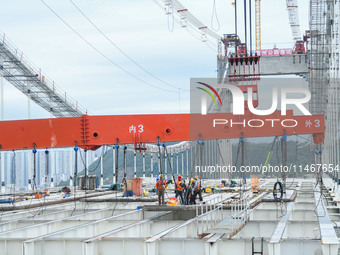 Workers are working at the construction site of Jinzhou Bridge in Xingyi, China, on August 11, 2024. (