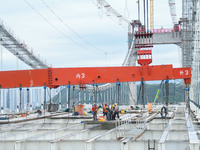 Workers are working at the construction site of Jinzhou Bridge in Xingyi, China, on August 11, 2024. (