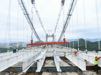 Workers are working at the construction site of Jinzhou Bridge in Xingyi, China, on August 11, 2024. (