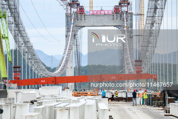 Workers are working at the construction site of Jinzhou Bridge in Xingyi, China, on August 11, 2024. 