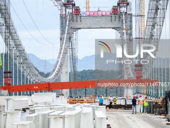 Workers are working at the construction site of Jinzhou Bridge in Xingyi, China, on August 11, 2024. (