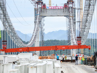 Workers are working at the construction site of Jinzhou Bridge in Xingyi, China, on August 11, 2024. (