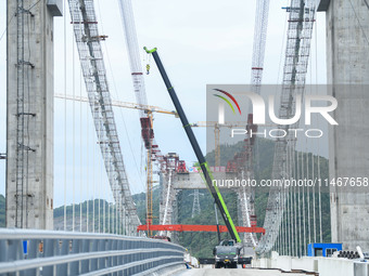 Workers are working at the construction site of Jinzhou Bridge in Xingyi, China, on August 11, 2024. (