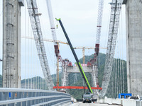 Workers are working at the construction site of Jinzhou Bridge in Xingyi, China, on August 11, 2024. (