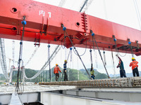 Workers are working at the construction site of Jinzhou Bridge in Xingyi, China, on August 11, 2024. (