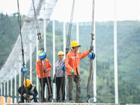 Workers are working at the construction site of Jinzhou Bridge in Xingyi, China, on August 11, 2024. (