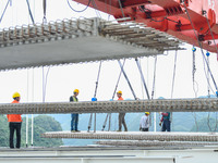 Workers are working at the construction site of Jinzhou Bridge in Xingyi, China, on August 11, 2024. (