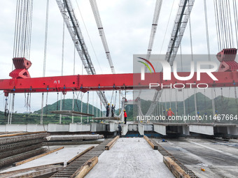 Workers are working at the construction site of Jinzhou Bridge in Xingyi, China, on August 11, 2024. (