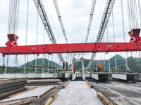 Workers are working at the construction site of Jinzhou Bridge in Xingyi, China, on August 11, 2024. (