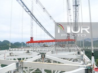 Workers are working at the construction site of Jinzhou Bridge in Xingyi, China, on August 11, 2024. (