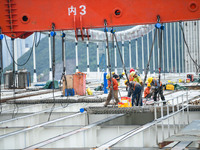 Workers are working at the construction site of Jinzhou Bridge in Xingyi, China, on August 11, 2024. (