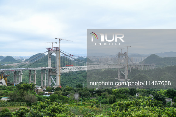 Workers are working at the construction site of Jinzhou Bridge in Xingyi, China, on August 11, 2024. 