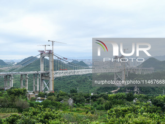 Workers are working at the construction site of Jinzhou Bridge in Xingyi, China, on August 11, 2024. (