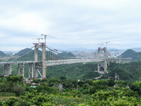 Workers are working at the construction site of Jinzhou Bridge in Xingyi, China, on August 11, 2024. (