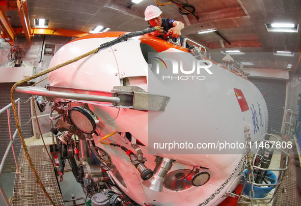 Expedition team members are inspecting the appearance and working condition of towed equipment in Qingdao, Shandong province, China, on Augu...