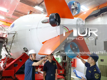 Customs officers of Qingdao Dagang Port are boarding a ship to carry out ship supervision work in Qingdao, Shandong province, China, on Augu...