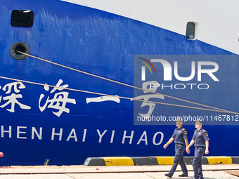 Customs officers of Qingdao Dagang Port are boarding a ship to carry out ship supervision work in Qingdao, Shandong province, China, on Augu...