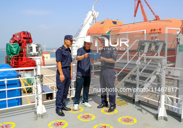 Customs officers at Qingdao Dagang are checking ship declaration documents on the spot in Qingdao, Shandong province, China, on August 11, 2...