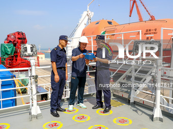 Customs officers at Qingdao Dagang are checking ship declaration documents on the spot in Qingdao, Shandong province, China, on August 11, 2...