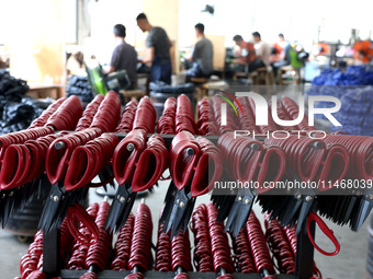 Workers of an enterprise are producing scissors on the production line at Yanshan Ocean Knife and Scissors Industrial Park in Zherong County...