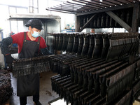 A worker of an enterprise is producing scissors on the production line at Yanshan Ocean Knife and Scissors Industrial Park in Zherong County...