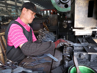 A worker of an enterprise is producing scissors on the production line at Yanshan Ocean Knife and Scissors Industrial Park in Zherong County...