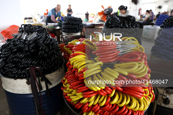 Workers of an enterprise are producing scissors on the production line at Yanshan Ocean Knife and Scissors Industrial Park in Zherong County...