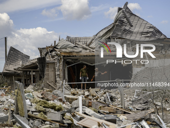 A residential building in a village in the Kyiv region is being heavily damaged during a massive Russian missile and drone attack on Ukraine...