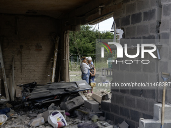 A residential building in a village in the Kyiv region is being heavily damaged during a massive Russian missile and drone attack on Ukraine...