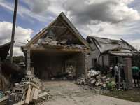 A residential building in a village in the Kyiv region is being heavily damaged during a massive Russian missile and drone attack on Ukraine...