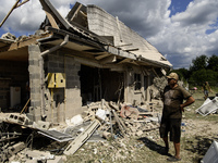 Local residents are cleaning up the residential building in a village in the Kyiv region, heavily damaged during a massive Russian missile a...