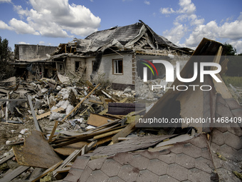 A residential building in a village in the Kyiv region is being heavily damaged during a massive Russian missile and drone attack on Ukraine...