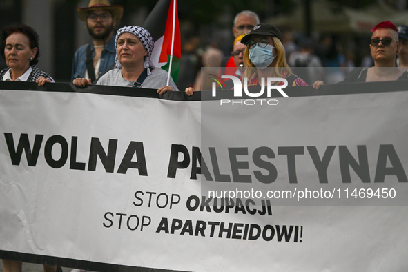 KRAKOW, POLAND - AUGUST 10:
Pro-Palestinian activists rally in Krakow's UNESCO-listed Old Town during the 'March for Palestine,' advocating...