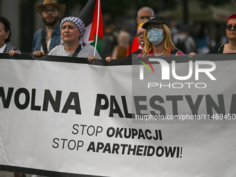 KRAKOW, POLAND - AUGUST 10:
Pro-Palestinian activists rally in Krakow's UNESCO-listed Old Town during the 'March for Palestine,' advocating...