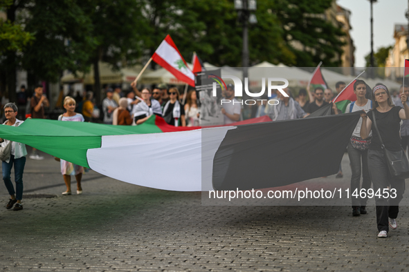 KRAKOW, POLAND - AUGUST 10:
Pro-Palestinian activists rally in Krakow's UNESCO-listed Old Town during the 'March for Palestine,' advocating...