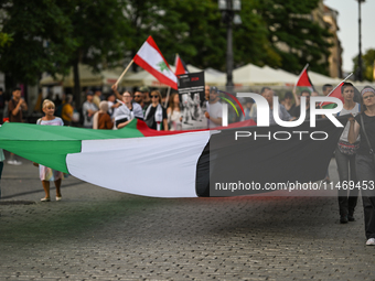 KRAKOW, POLAND - AUGUST 10:
Pro-Palestinian activists rally in Krakow's UNESCO-listed Old Town during the 'March for Palestine,' advocating...