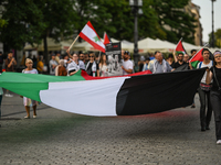 KRAKOW, POLAND - AUGUST 10:
Pro-Palestinian activists rally in Krakow's UNESCO-listed Old Town during the 'March for Palestine,' advocating...