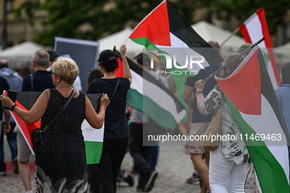 KRAKOW, POLAND - AUGUST 10:
Pro-Palestinian activists rally in Krakow's UNESCO-listed Old Town during the 'March for Palestine,' advocating...