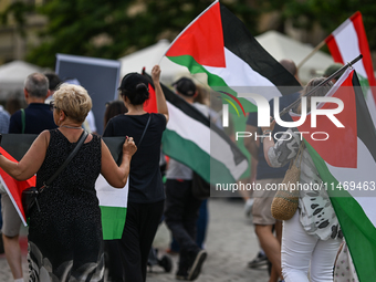 KRAKOW, POLAND - AUGUST 10:
Pro-Palestinian activists rally in Krakow's UNESCO-listed Old Town during the 'March for Palestine,' advocating...