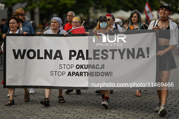 KRAKOW, POLAND - AUGUST 10:
Pro-Palestinian activists rally in Krakow's UNESCO-listed Old Town during the 'March for Palestine,' advocating...