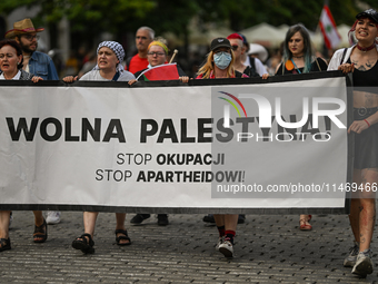 KRAKOW, POLAND - AUGUST 10:
Pro-Palestinian activists rally in Krakow's UNESCO-listed Old Town during the 'March for Palestine,' advocating...