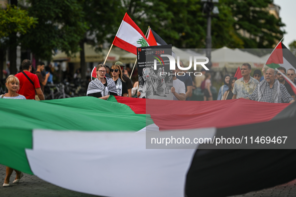 KRAKOW, POLAND - AUGUST 10:
Pro-Palestinian activists rally in Krakow's UNESCO-listed Old Town during the 'March for Palestine,' advocating...