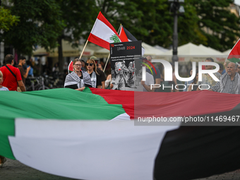 KRAKOW, POLAND - AUGUST 10:
Pro-Palestinian activists rally in Krakow's UNESCO-listed Old Town during the 'March for Palestine,' advocating...